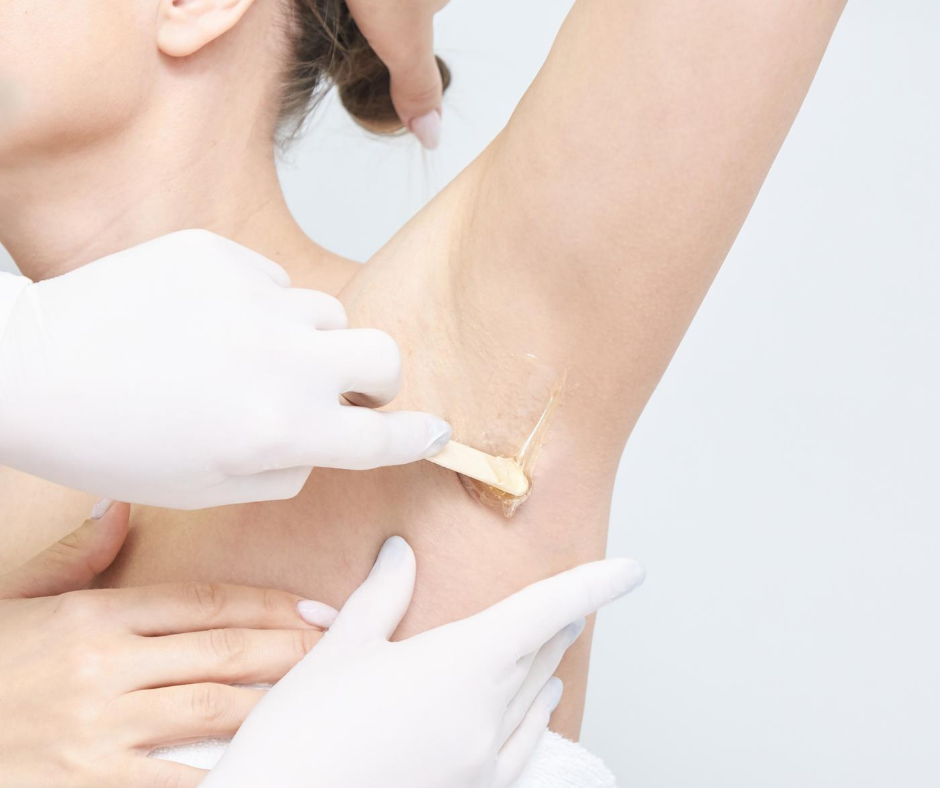 Applying body wax during a beauty treatment as part of studying body waxing in an online course.