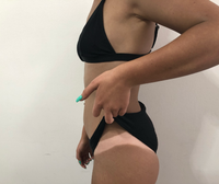 Learn Spray Tanning technique showcased by model with tan lines in black bikini demonstrating a sun-kissed look.