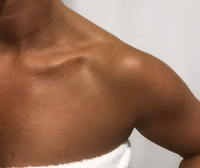 Learn Spray Tanning - Close-up of bronzed shoulder showcasing flawless skin after spray tanning.