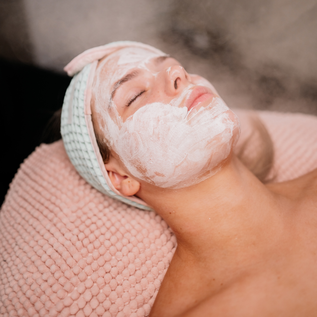 Woman receiving a facial treatment as part of Professional Beauty Services course from Bombshell Beauty Academy.